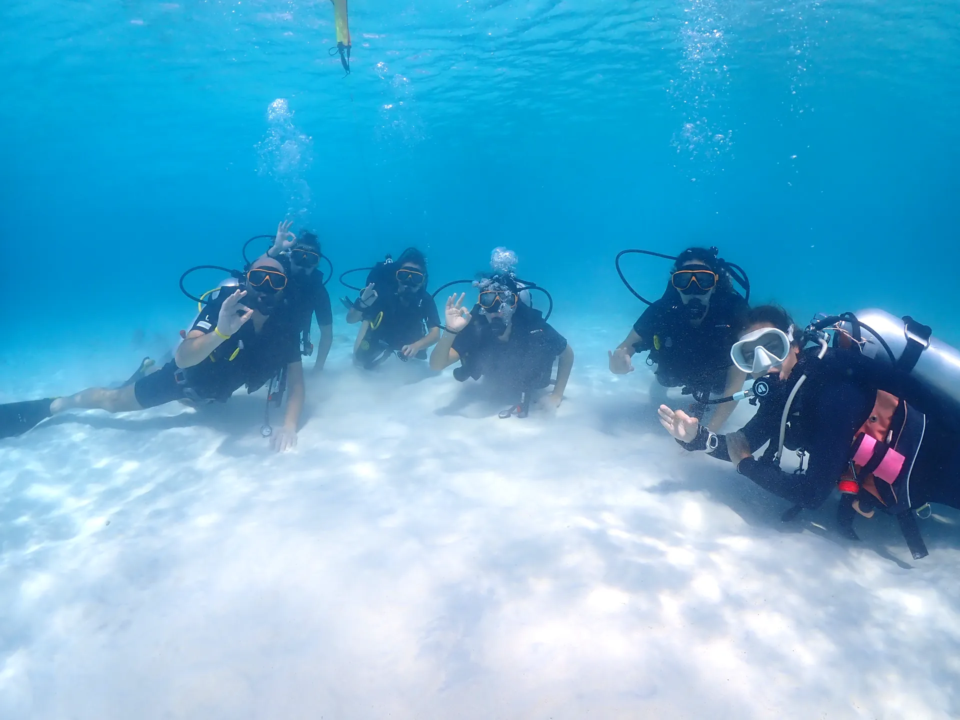 Beginner divers over a shallow coral reef in Koh Lipe