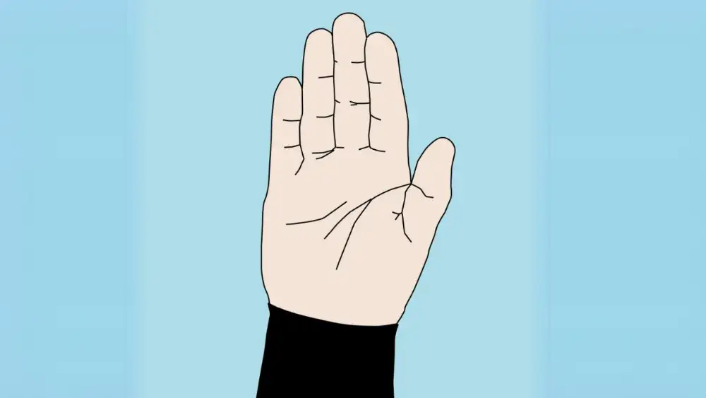 A diver underwater making the stop signal with an open palm facing forward