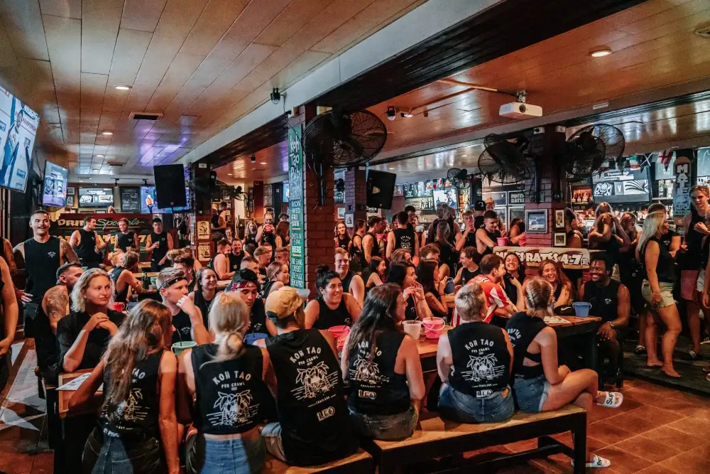 Chopper's Sports Bar in Sairee, Koh Tao, with its screens showing live sport and a crowd at the bar