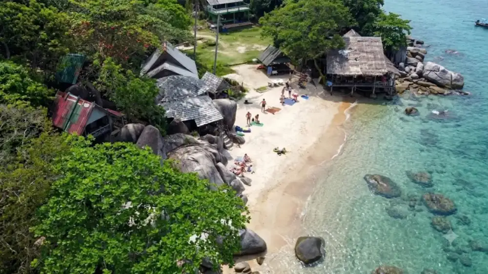 Sai Nuan Beach, a small secluded cove on Koh Tao's southwest coast with boulders, coconut palms and hammocks