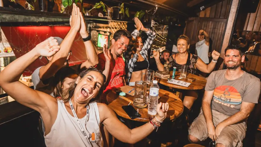 Koh Tao nightlife: people dancing at a beach bar lit by coloured lights, with a DJ playing on Sairee Beach