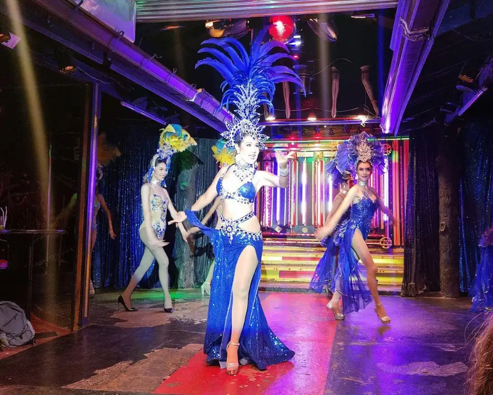 Performers in glittering costumes on stage at Queen's Cabaret in Sairee, Koh Tao