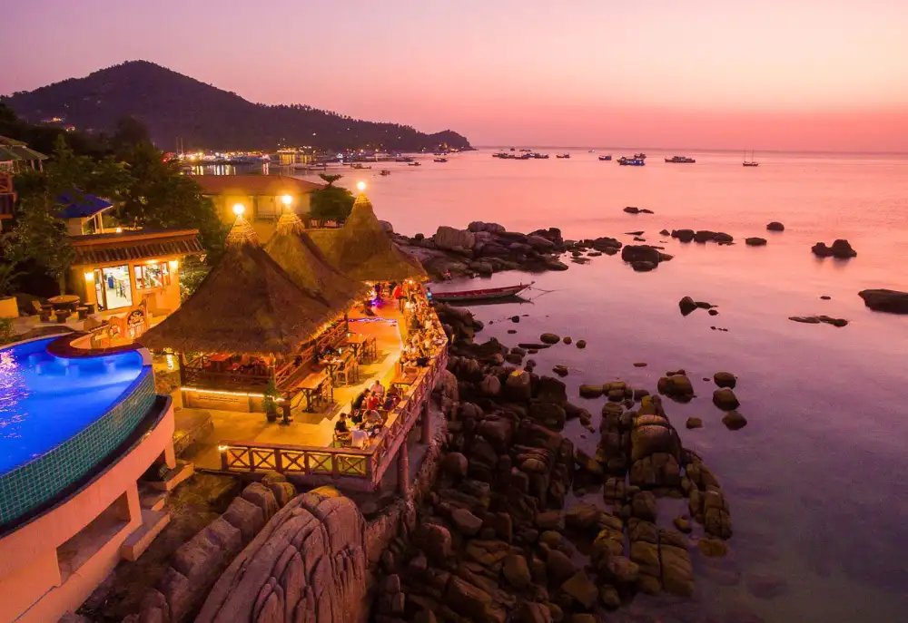 A whole grilled fish served with lime and dipping sauce at a seaside Thai restaurant