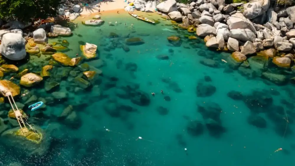 Hin Wong Bay on Koh Tao's northeast coast, a rocky bay with clear water and boulders along the shoreline