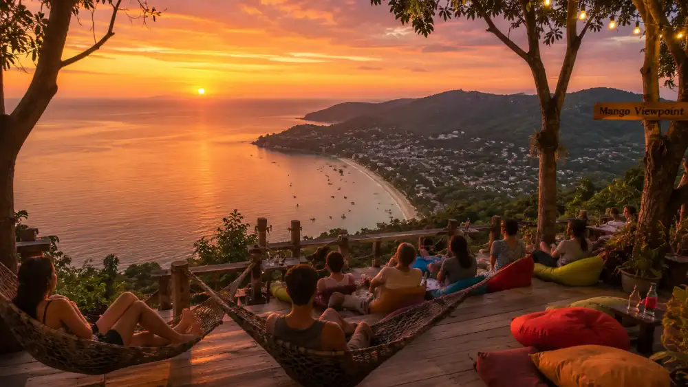 Mango viewpoint at sunset: wooden platforms and hammocks high in the northern hills looking down over Koh Tao's west coast