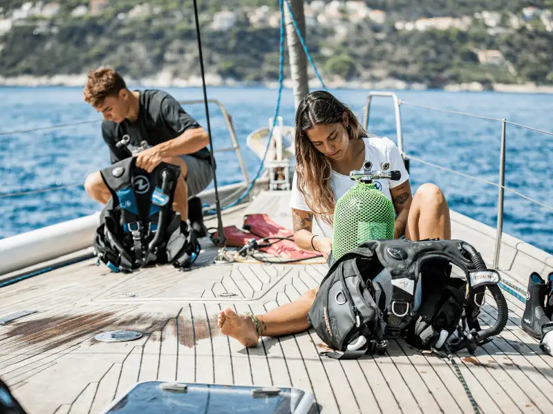 A dive equipment repair facility with regulators and tools laid out on a workbench
