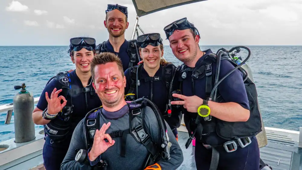 Diving instructors and divemaster candidates developing their careers together on a Koh Tao dive boat