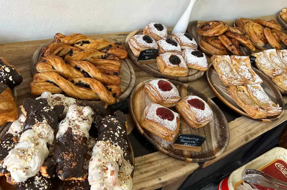 A display of freshly baked French pastries and cakes at The French Market, Koh Tao