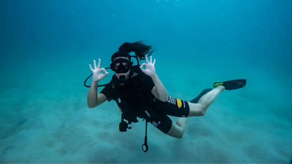 A diver gliding over a coral reef during a fun dive in Koh Tao