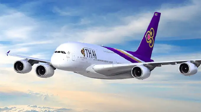 A Thai Airways aircraft on the ground at an airport