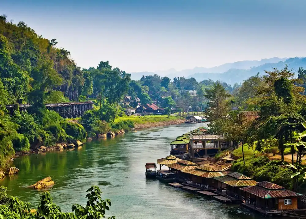 The River Kwai winding through the green hills of Kanchanaburi, northern Thailand