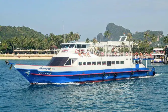 A high-speed passenger ferry docked at the pier on Koh Phi Phi, ready for the crossing to Krabi