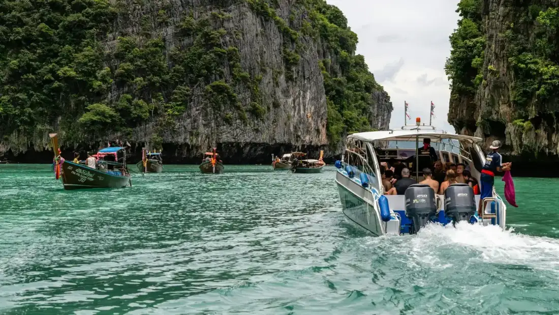 A high-speed passenger ferry crossing the Gulf of Thailand towards Koh Tao on a sunny day