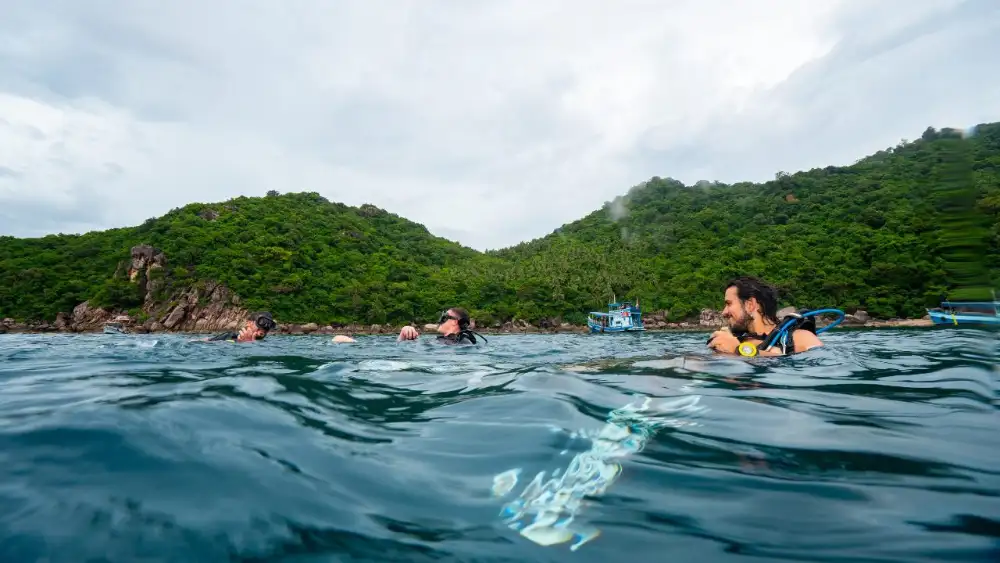 Divers on the deck of a La Bombona Diving boat off Koh Tao, ready for the first dive after the journey