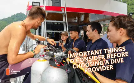 A dive instructor briefing a group of students on a dive boat off Koh Tao before entering the water