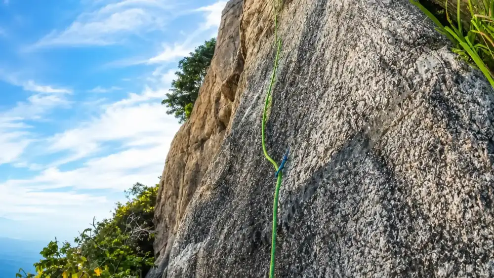 A climber on one of Koh Tao's granite boulders during a guided rock climbing session