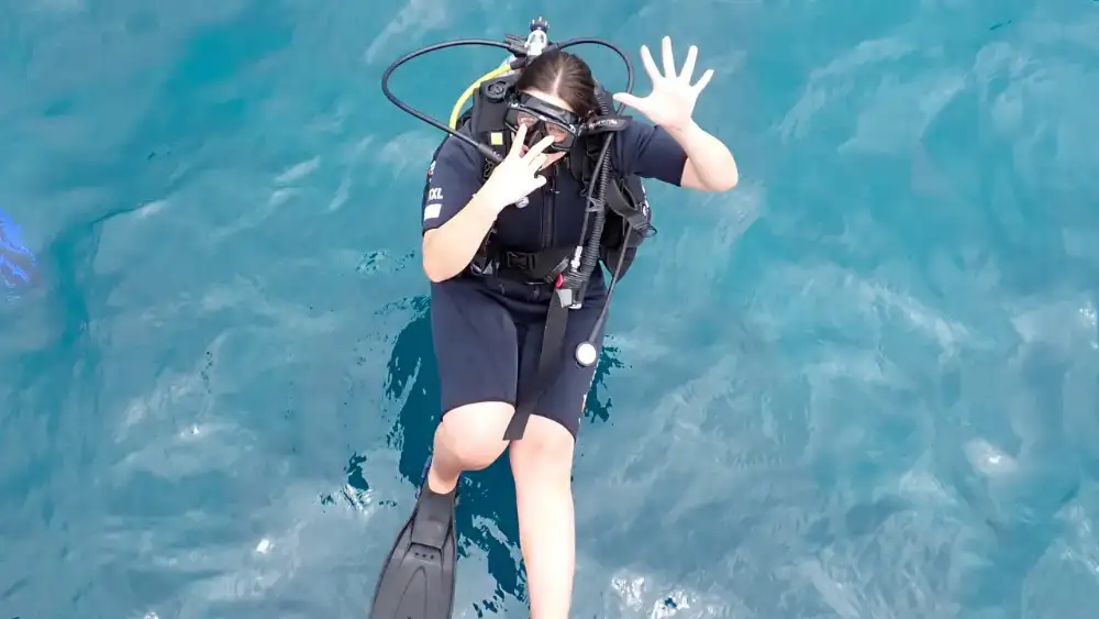Snorkellers exploring a quiet coral bay on a guided boat tour around Koh Tao