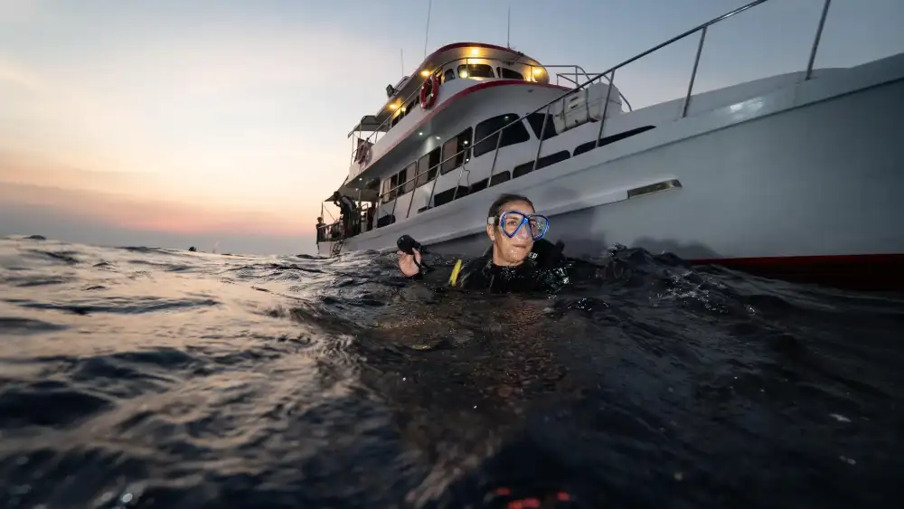 A woman scuba diver floating calmly at the water surface during a break between dives