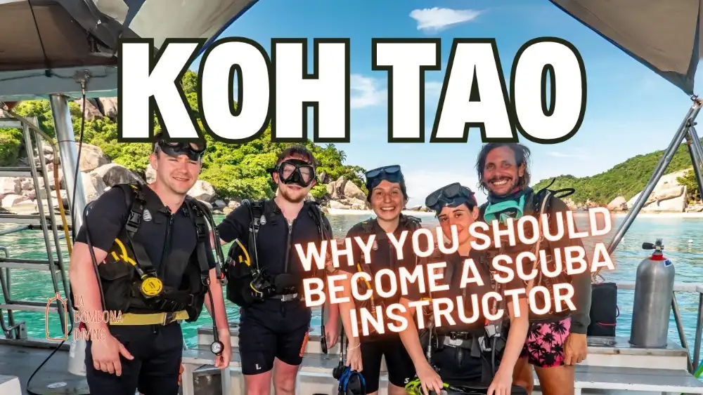 A scuba instructor briefing a group of students on the deck of a dive boat in Koh Tao